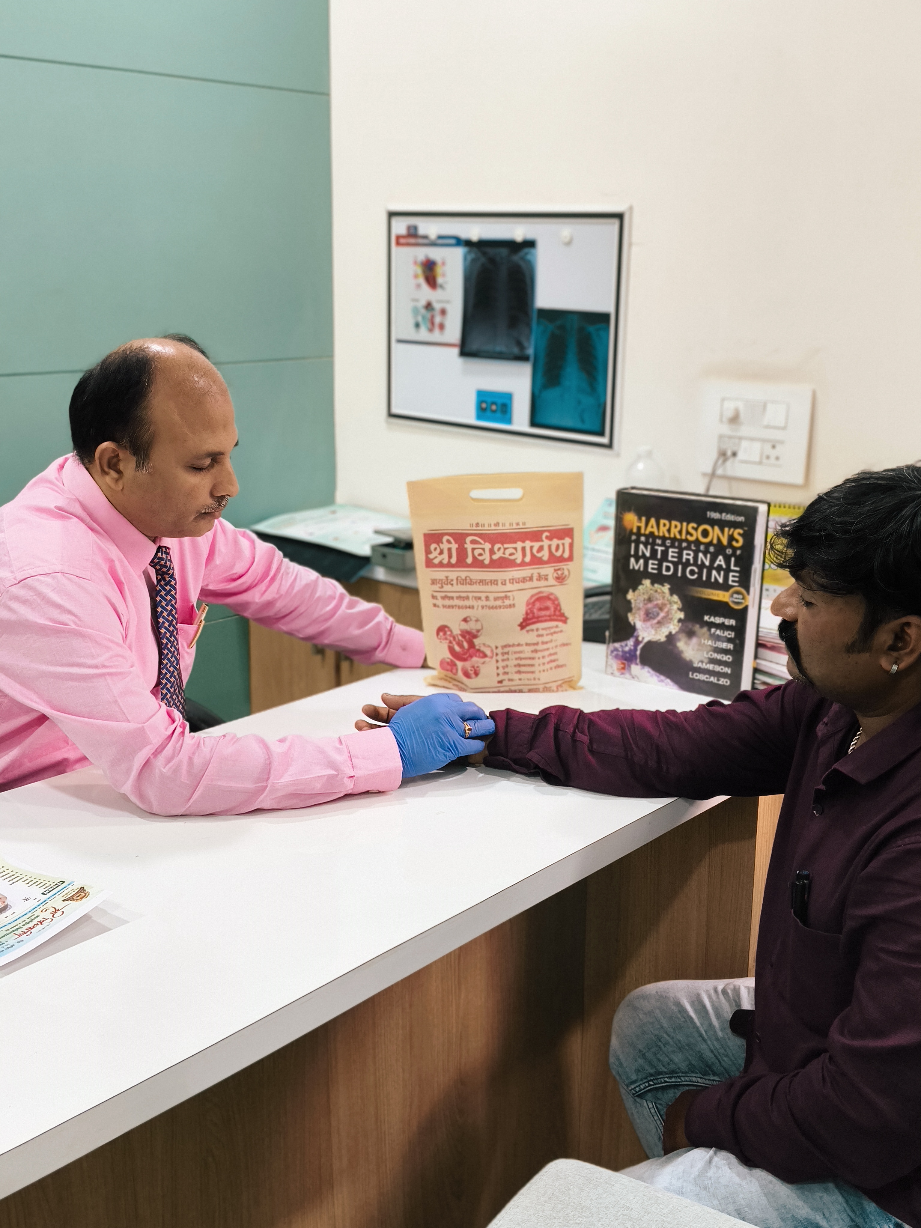 Dr Sachin Godse consulting a patient