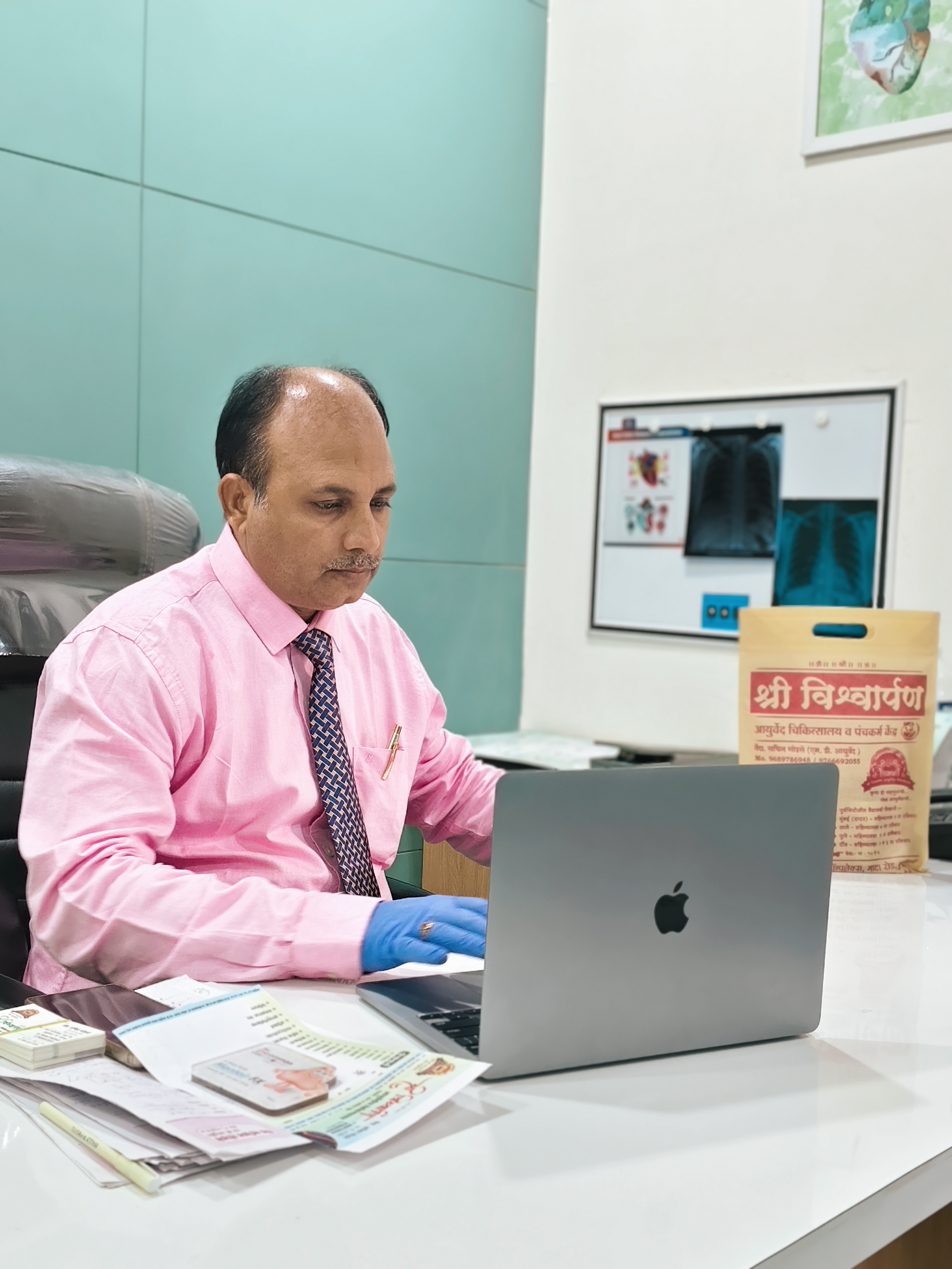 Dr Sachin Godse working at clinic desk